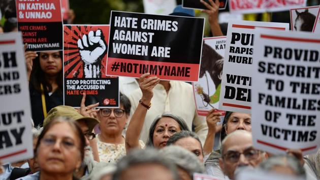 Demonstrators hold placards during a 'Not In My Name' protest in support of rape victims in New Delhi.(AFP)