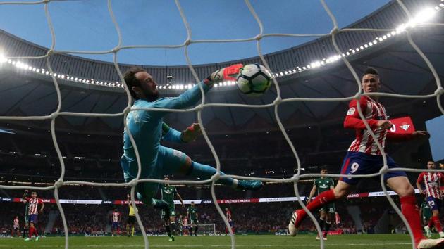 Real Betis' Dani Gimenez saves a shot from Atletico Madrid's Fernando Torres during their Spanish La Liga match on Sunday.(REUTERS)