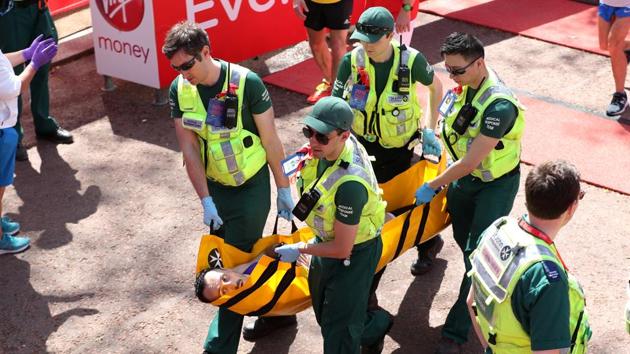 A runner receives medical attention after the London Marathon on Sunday.(Reuters)