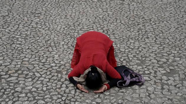 A Buddhist person prays in front of the site of Beichuan Middle School which was buried by boulders in the 2008 Sichuan earthquake in Beichuan, Sichuan province, China. A decade after a massive earthquake rocked this southwestern province in China, killing almost 70,000 people, the scars have begun to heal. (Jason Lee / REUTERS)