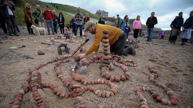 A competitor take works on his claim to the title in the Stone Stacking Championship. “(It’s) the most ancient art form that there is,” James Craig Page, the fledgling contest’s founder, told AFP. Despite stone stacking’s lofty history, he traces the modern-day challenge to the creations of Californian stacker Bill Dan in the early 1990s. (Andy Buchanan / AFP)