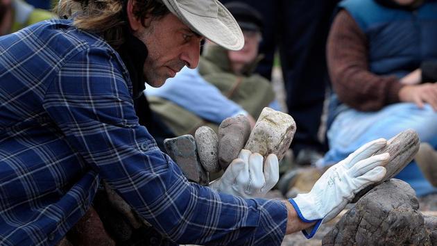 Pedro Duran from Spain, works on his sculpture. Page launched the contest last year after organising a more local event -- the John Muir challenge -- in 2016, which was billed as the first stone stacking competition of its kind in Britain. (Andy Buchanan / AFP)