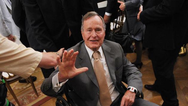 In this file photo taken on May 31, 2012 former US President George H.W. Bush waves as he leaves the East Room following the official portrait unveiling of his son former US President George W. Bush and his wife Laura Bush at the White House in Washington, DC.(AFP File Photo)
