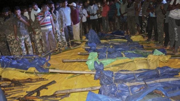 Indian security personnel stand next to bodies of killed Maoist rebels in Rela-Kasnasur forest in Gadchilori district in Maharashtra on April 22, 2018. At least six Maoists were killed in a fresh gunfight in Maharashtra’s Gadchiroli district and 15 more bodies were recovered from the Sunday encounter in the same region where 16 rebels had died in an operation by security forces. (AP) Indian security personnel stand next to bodies of killed Maoist rebels in Rela-Kasnasur forest in Gadchilori district in Maharashtra on April 22, 2018. At least six Maoists were killed in a fresh gunfight in Maharashtra’s Gadchiroli district and 15 more bodies were recovered from the Sunday encounter in the same region where 16 rebels had died in an operation by security forces. (AP)