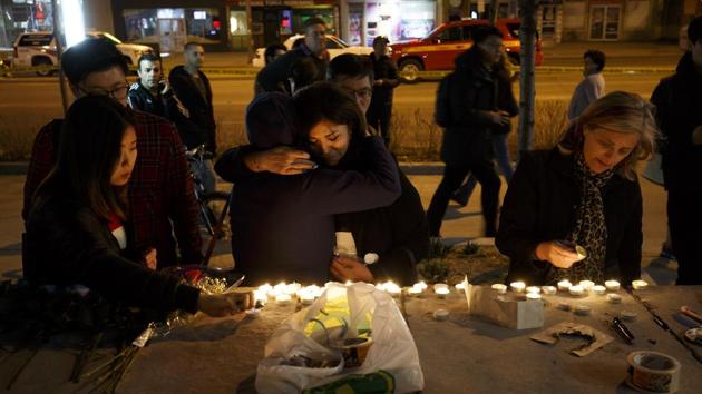 People embrace as they lay candles and leave messages at a memorial for victims of a crash on Yonge Street. The tragedy in Toronto struck as Canada was still shaken by a highway crash in Saskatchewan earlier this month that took the lives of 16 people on a bus carrying a junior hockey team. (Cole Burston / Getty Images / AFP) People embrace as they lay candles and leave messages at a memorial for victims of a crash on Yonge Street. The tragedy in Toronto struck as Canada was still shaken by a highway crash in Saskatchewan earlier this month that took the lives of 16 people on a bus carrying a junior hockey team. (Cole Burston / Getty Images / AFP)