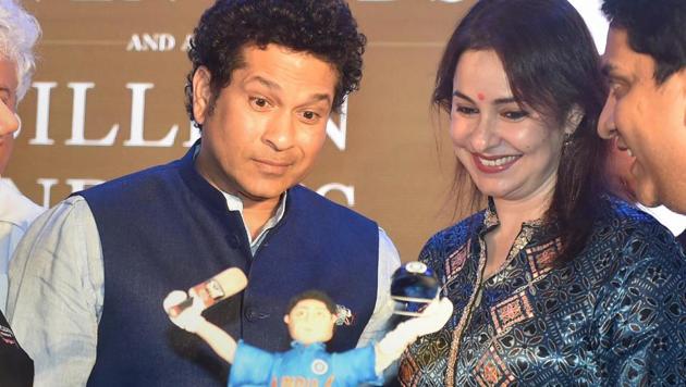 Sachin Tendulkar cuts a birthday cake with wife Anjali at a book launch function on Monday in Mumbai on the eve of his 45th birthday.(PTI)