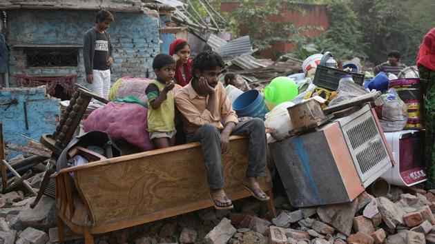 As residents moved out, demolitions in the colony took their place, paving the way for the redevelopment. In October 2017, a demolition drive seeking to relocate the 1,355 families who had stayed put over the years razed hundreds of homes. Residents were apprehensive of shifting to transit camps or further to Narela citing inconveniences to livelihood. (Sanchit Khanna / HT Archive)