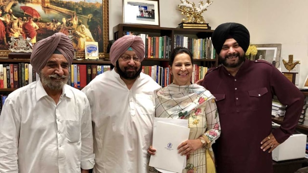 Punjab chief minister Amarinder Singh handed the appointment letter to Navjot Kaur Sidhu, who was accompanied by her husband Navjot Singh Sidhu (right) and rural development minister Tript Rajinder Singh Bajwa (left), at his official residence .(HT Photo)
