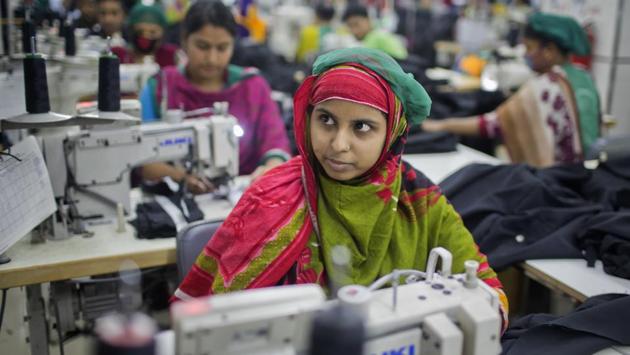 Khadiza Begum, 23, who was trapped for hours after the Rana Plaza collapse was so shaken by the experience she didn’t work for two years. Eventually, with her family desperately needing money, she got a job at Snowtex. “It’s very different here,” she said, sitting in front of a sewing machine. “This building is good and strong.” (A.M. Ahad / AP)