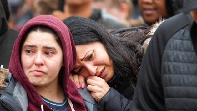 A woman cries after placing a memorial at a vigil on April 24, 2018 in Toronto, Canada, near the site of a deadly street van attack.(AFP)