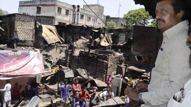 Anil Shirole Pune MP visited Ambedkarnagar behind Market Yard a day after a major fire gutted a part of the slum. Several tin houses were gutted in a major fire at the Ambedkarnagar slum area in Market Yard area on Saturday (April 21). At least 12 fire units and water tankers rushed to the spot. Residents said that the fire broke out due to a short circuit in a house and spread to nearby homes. No casualty was reported. The narrow entrance to the slum area prevented the fire trucks from entering the area.  (Ravindra Joshi/HT PHOTO) 