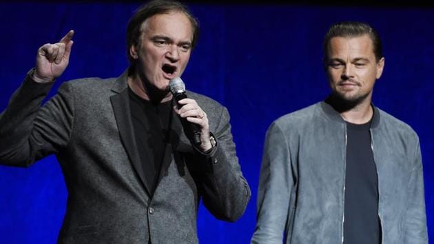 Quentin Tarantino, left, writer/director of the upcoming film Once Upon a Time in Hollywood, discusses the project as cast member Leonardo DiCaprio looks on during the Sony Pictures Entertainment presentation at CinemaCon 2018.(Chris Pizzello/Invision/AP)