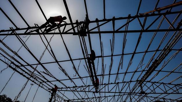 Workers build a tent at Shivaji Park in preparation for the event. The day is marked as a public holiday, with all schools, offices, banks, and stock markets remaining shut. (sKunal Patil/HT Photo) 