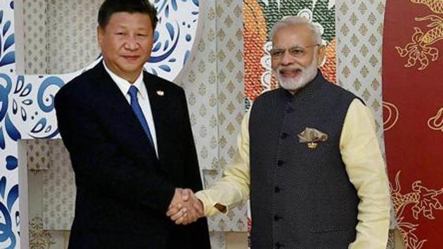 File photo of Prime Minister Narendra Modi with Chinese President Xi Jinping at the BRICS Summit in Goa in 2016.(PTI)