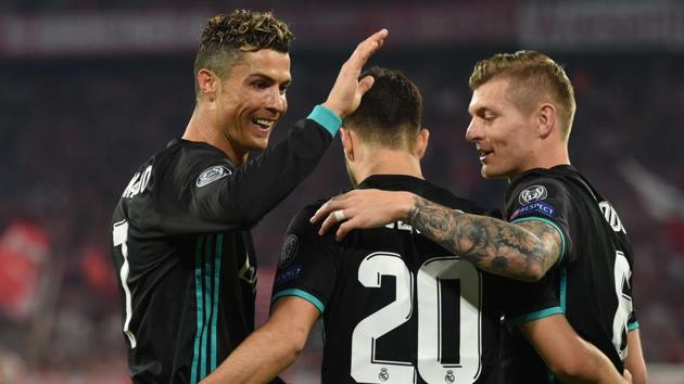 Real Madrid's Spanish midfielder Marco Asensio (C) celebrates with Cristiano Ronaldo (L) and Toni Kroos after scoring a goal during the UEFA Champions League semi-final first-leg clash against FC Bayern Munich in Munich on Wednesday.(AFP)