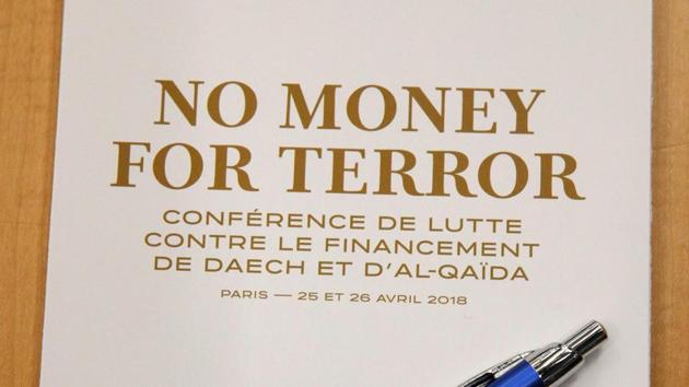 A program is seen before the start of a round table at a conference to discuss ways of cutting funding to groups including Islamic State and al-Qaeda, at the Organisation for Economic Co-operation and Development (OECD) headquarters in Paris on April 26.(AFP Photo)