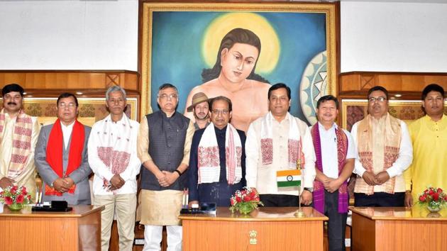 Assam governor Jagdish Mukhi and chief minister Sarbananda Sonowal with newly sworn-in cabinet ministers and ministers of state with independent charge after the swearing-in ceremony, at Raj Bhawan in Guwahati. A former Bodo terrorist, student leader, folk singer, RSS worker and two ex-Congressmen are among the seven new ministers inducted into Assam’s BJP-led government on Thursday. (PTI)