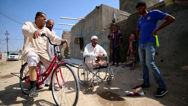 Rafed, a man disabled by a landmine explosion, rides his bicycle in the village. In 1991, the village, like the rest of Iraq, descended deeper into poverty as a result of international sanctions imposed on the country following the occupation of Kuwait. (Essam Al-Sudani / REUTERS) 