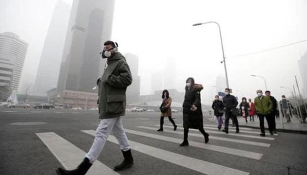A man wearing a respiratory protection mask walks toward an office building during the smog after a red alert was issued for heavy air pollution in Beijing's central business district, China.(Reuters File Photo) A man wearing a respiratory protection mask walks toward an office building during the smog after a red alert was issued for heavy air pollution in Beijing's central business district, China.(Reuters File Photo)