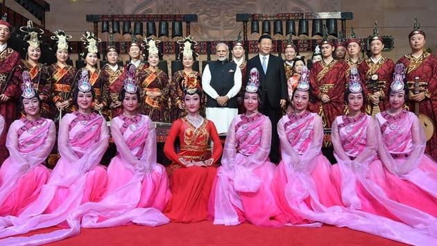 PM Narendra Modi (C) and Chinese President Xi Jinping pose with performers at the Hubei Museum in Wuhan. Modi drew parallels between India and China during a one-to-one meeting with Xi Jinping at the museum. “The culture of both India and China is based along the river banks. If we talk about Mohenjo Daro and Harappa civilizations in India, all the development happened along river banks,” he told Xi during the interaction. (PIB / AFP)