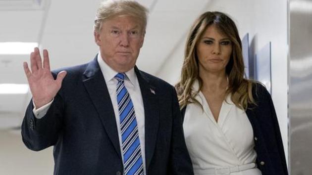 President Donald Trump, center, accompanied by first lady Melania Trump.(AP)