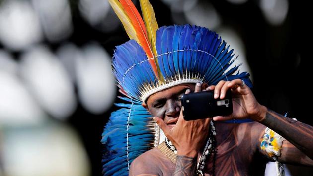 A Brazilian Indigenou checks his face in a mobile phone at the Terra Livre camp, or Free Land camp, during a demonstration in defence of local indigenous people, in Brasilia, Brazil. (Adriano Machado / REUTERS) A Brazilian Indigenou checks his face in a mobile phone at the Terra Livre camp, or Free Land camp, during a demonstration in defence of local indigenous people, in Brasilia, Brazil. (Adriano Machado / REUTERS)