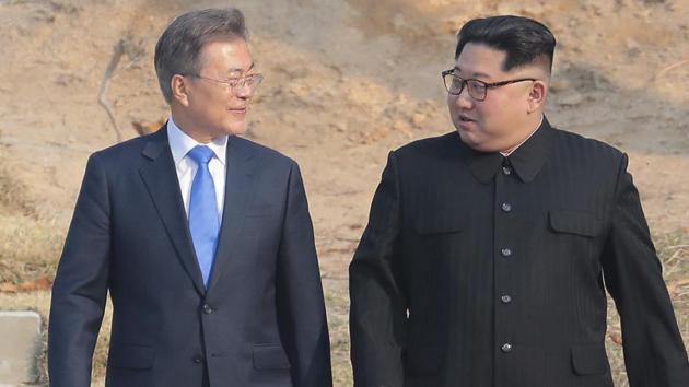 North Korean leader Kim Jong Un (right), and South Korean President Moon Jae-in stroll together at the border village of Panmunjom in the Demilitarized Zone, South Korea, on April 27, 2018.(AP)