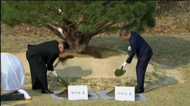 South Korean President Moon Jae-in and North Korean leader Kim Jong Un attend tree planting ceremony during the inter-Korean summit at the truce village of Panmunjom, in this still frame taken from video, South Korea April 27, 2018.(REUTERS)