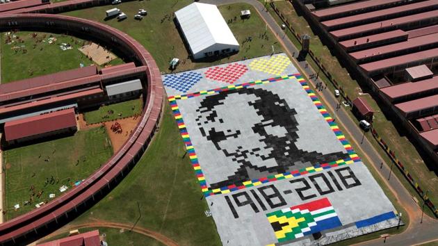 An aerial view of a “Massive Mandela Masterpiece” made up of crochet blankets which is unveiled at Zonderwater Prison outside Cullinan in South Africa. The South Africa Department of Correctional Services unveiled the giant portrait made of blankets as part of the celebrations of the centenary year Nelson Mandela. (John Hogg / 67 Blankets / AFP) An aerial view of a “Massive Mandela Masterpiece” made up of crochet blankets which is unveiled at Zonderwater Prison outside Cullinan in South Africa. The South Africa Department of Correctional Services unveiled the giant portrait made of blankets as part of the celebrations of the centenary year Nelson Mandela. (John Hogg / 67 Blankets / AFP)