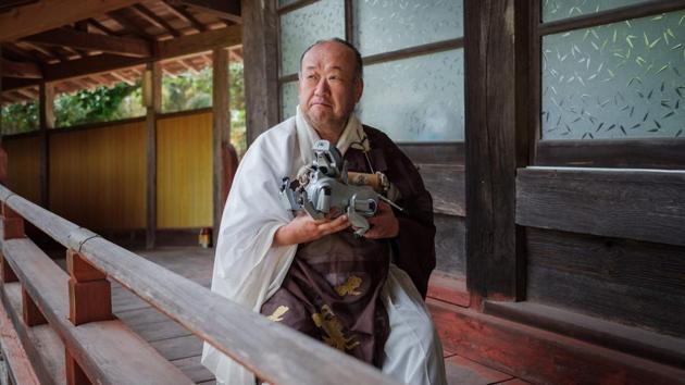 Kofukuji temple chief priest Bungen Oi holds a Sony's pet robot AIBO after a robots' funeral at the Kofukuji temple in Isumi, Japan. (Nicolas Datiche / AFP) Kofukuji temple chief priest Bungen Oi holds a Sony's pet robot AIBO after a robots' funeral at the Kofukuji temple in Isumi, Japan. (Nicolas Datiche / AFP)