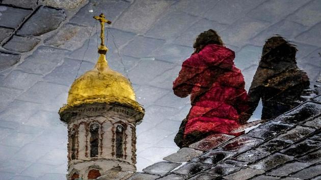 Women are reflected in a puddle as they walk across Red Square in Moscow, Russia. (Yuri Kadobnov / AFP) Women are reflected in a puddle as they walk across Red Square in Moscow, Russia. (Yuri Kadobnov / AFP)