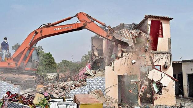 An earth-moving machine demolishing a structure at Khuda Alisher village in Chandigarh on Friday. (Sikander Singh Chopra/HT) An earth-moving machine demolishing a structure at Khuda Alisher village in Chandigarh on Friday. (Sikander Singh Chopra/HT)