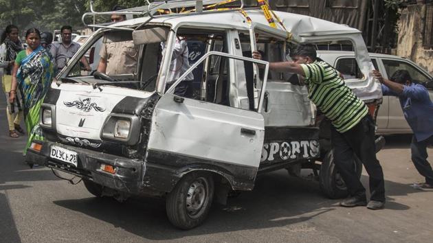 A mangled school van is being removed from the road after it collided with a tanker near Kanhaiya Nagar metro station in north-west Delhi.(PTI FILE)