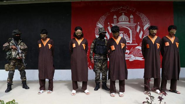 Afghan security forces stand next to arrested Taliban militants in Ghazni province on April 14, 2018.(AFP FILE)