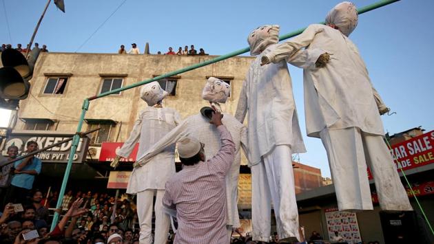 A man beats an effigy of one of the rapists at a protest against the rape of an eight-year-old girl, in Kathua, a teenager in Unnao and an eleven-year-old girl in Surat, in Ahmedabad, Gujarat on April 22, 2018. (Amit Dave / REUTERS) A man beats an effigy of one of the rapists at a protest against the rape of an eight-year-old girl, in Kathua, a teenager in Unnao and an eleven-year-old girl in Surat, in Ahmedabad, Gujarat on April 22, 2018. (Amit Dave / REUTERS)
