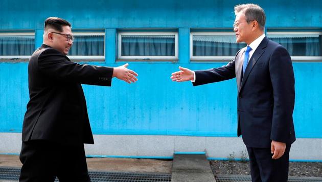 North Korean leader Kim Jong Un, left, prepares to shake hands with South Korean President Moon Jae-in over the military demarcation line at the border village of Panmunjom in Demilitarized Zone Friday, April 27, 2018. (AP) North Korean leader Kim Jong Un, left, prepares to shake hands with South Korean President Moon Jae-in over the military demarcation line at the border village of Panmunjom in Demilitarized Zone Friday, April 27, 2018. (AP)