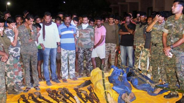 Security personnel show the guns recovered from the Maoists killed in an encounter at Broriya forest area in Bhamragad taluka of Gadchiroli district of Maharashtra on Sunday night.(PTI Photo)