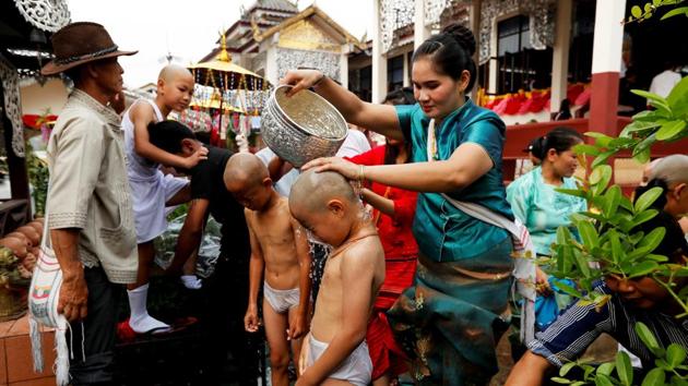 The boys are then bathed with scented water. The event is a rite of passage to initiate the boys as Buddhist novices, the highlight of an annual celebration by the Shan ethnic group that lives mainly in neighbouring Myanmar, but is also spread through China, Laos and Thailand. (Jorge Silva / REUTERS) 