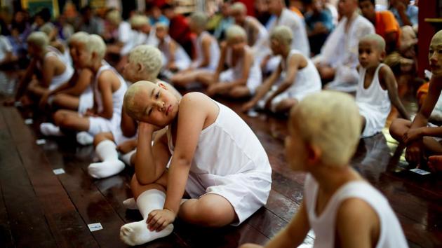 They dress in white and have patterns drawn on their faces and heads with a yellow cosmetic paste made from ground-up thanaka bark thought to have protective properties. The ordination is thought to bring honour to their families, and the event runs for a week during the dry season before the traditional Thai New Year, when most villagers are home children are on a school break. (Jorge Silva / REUTERS) 