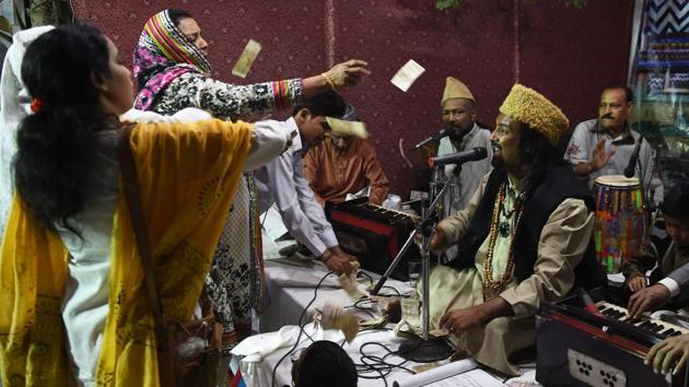 Qawwali singer Talha Sabri (C) performs with his group during an event in Karachi. Inflationary pressures have also kept the qawwals’ working-class fanbase from hosting shows. Increasingly only the middle class or elite can afford a qawwali group performing at parties or weddings. Singer Hashim Ali, says he is now lucky to play four or five shows during religious periods compared to dozens in the past. (Asif Hassan / AFP) 