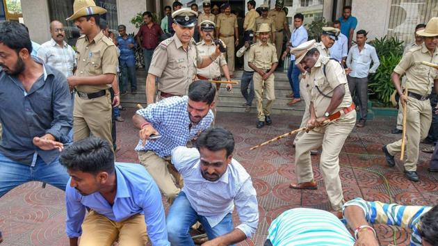 Police attempt to control a protest by the supporters of Karnataka BJP chief's son B Y Vijayendra who failed to get Assembly ticket to contest from Varuna, in Mysuru, Karnataka on April 24, 2018. (PTI) Police attempt to control a protest by the supporters of Karnataka BJP chief's son B Y Vijayendra who failed to get Assembly ticket to contest from Varuna, in Mysuru, Karnataka on April 24, 2018. (PTI)