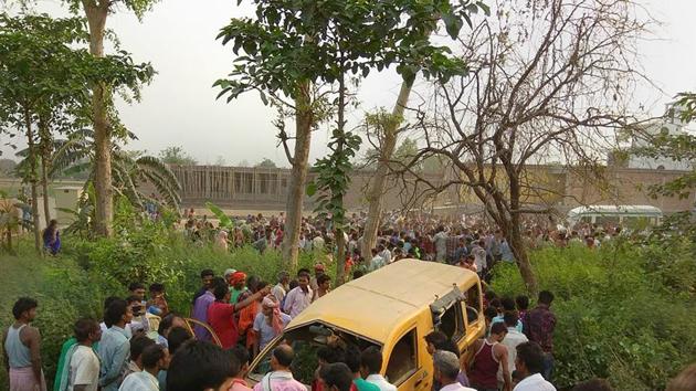 People gather around a mangled school van after it collided with a moving train in Kushinagar, Uttar Pradesh, on April 26, 2018. (PTI) People gather around a mangled school van after it collided with a moving train in Kushinagar, Uttar Pradesh, on April 26, 2018. (PTI)