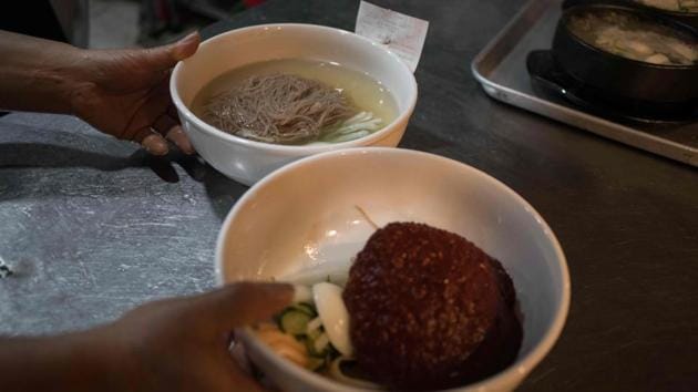 A chef prepares a 'Pyongyang naengmyeon' a cold noodle dish at the Nampo Myeonok noodle bar restaurant in Seoul.(AFP)