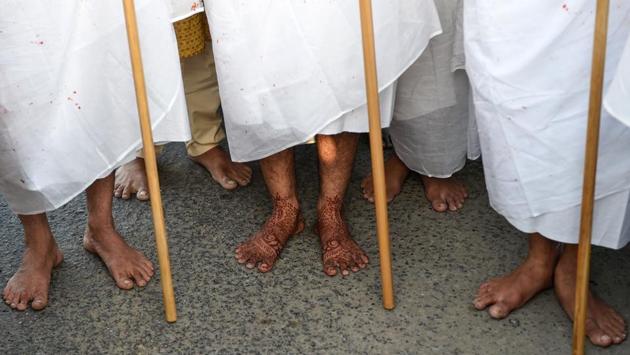 Sanjaybhai Shah (L), his son Darshil Shah (C), and Dharmeshbhai Shah (R) stand together after a ceremony where they renounced their material lifestyles to become Jain monks on the outskirts of Ahmedabad, Gujarat on April 25, 2018. (Sam Panthaky / AFP) Sanjaybhai Shah (L), his son Darshil Shah (C), and Dharmeshbhai Shah (R) stand together after a ceremony where they renounced their material lifestyles to become Jain monks on the outskirts of Ahmedabad, Gujarat on April 25, 2018. (Sam Panthaky / AFP)