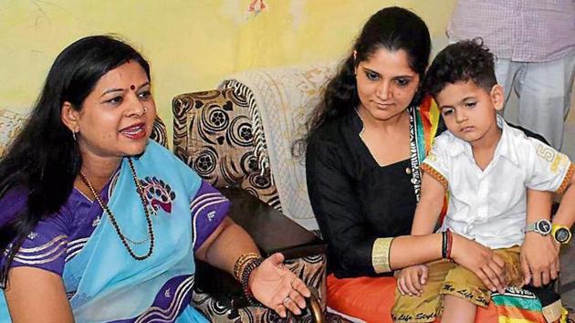 Haryana urban local bodies minister Kavita Jain with Anu Kumari and her son in Sonepat.(Manoj Dhaka/HT)