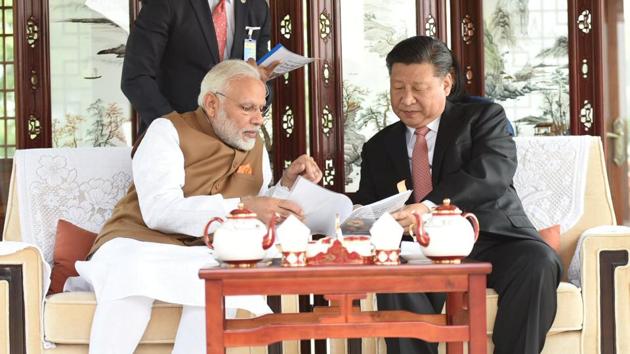 Chinese President Xi Jinping and India's Prime Minister Narendra Modi sit as they take a boat ride on the East Lake in Wuhan, China, Saturday.(Reuters Photo)