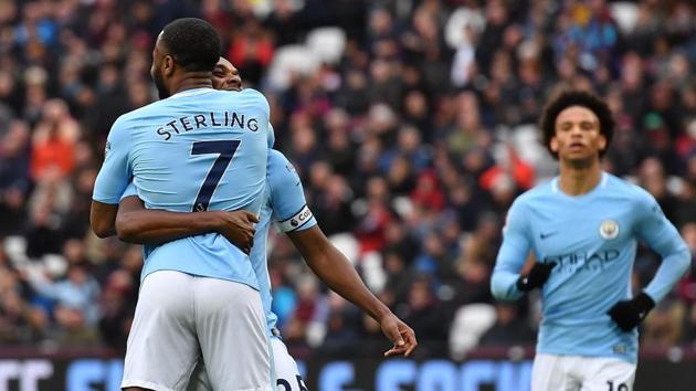 Manchester City's Fernandinho lifts up Manchester City's English midfielder Raheem Sterling (L) as he celebrates after scoring their fourth goal during the English Premier League match between West Ham United and Manchester City at The London Stadium, in east London on April 29, 2018. (AFP) Manchester City's Fernandinho lifts up Manchester City's English midfielder Raheem Sterling (L) as he celebrates after scoring their fourth goal during the English Premier League match between West Ham United and Manchester City at The London Stadium, in east London on April 29, 2018. (AFP)