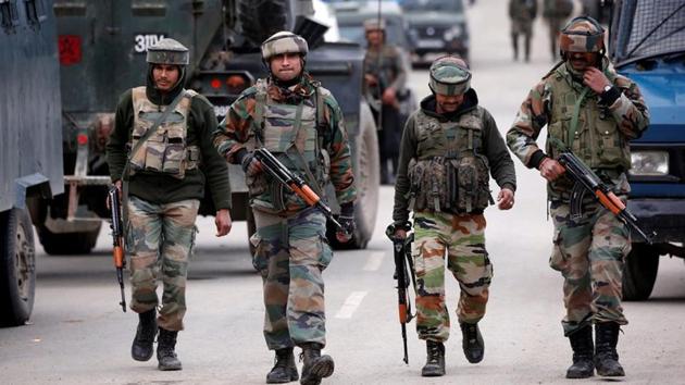 Army soldiers patrol a street near the site of a gunbattle between security forces and suspected militants in Khudwani village of south Kashmir's Kulgam district, on April 11, 2018.(REUTERS)
