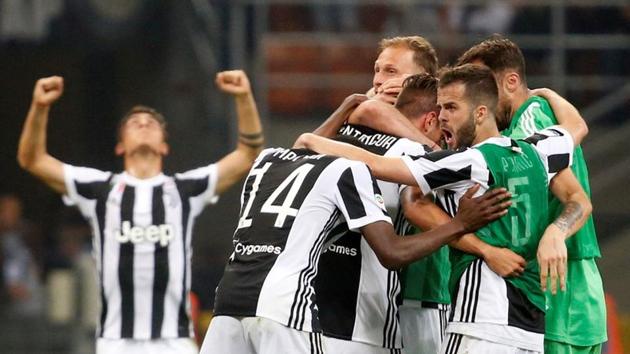 Juventus players celebrate after their win over Inter Milan in Serie A at San Siro, Milan, on Saturday.(Reuters)