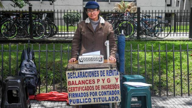 Inserting a blank sheet into her Remington Sperry, Candelaria Pinilla, 63, starts typing in Bogota, Colombia. Once upon a time, street clerks like her played an essential role -- with public deeds, tax documents and contracts all passing through their hands. And until now, they managed to survive pretty much everything -- except perhaps the advent of the internet. (Luis Acosta / AFP)